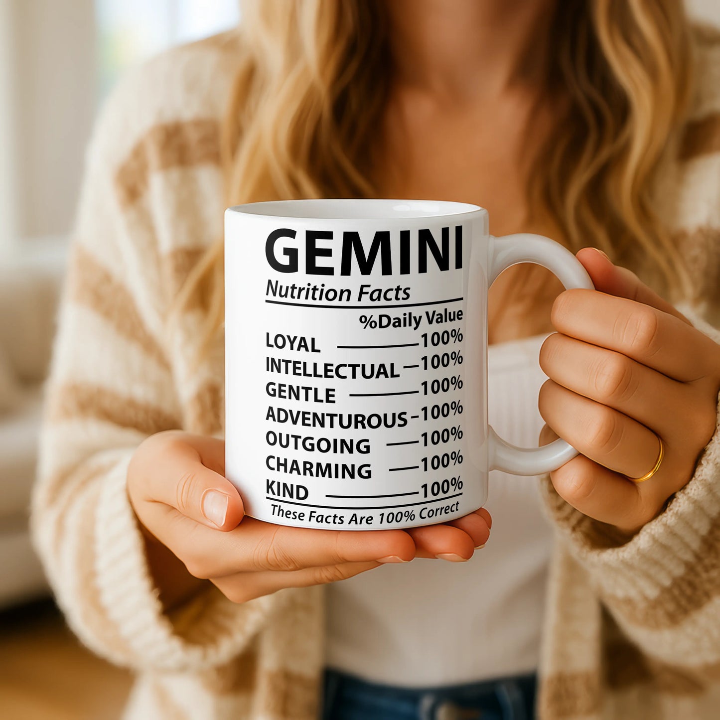 Person holding a mug with 'Gemini Nutrition Facts' text